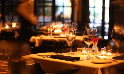 Glasses of wine sitting on a candlelit table at a fine dining restaurant in Bala Cynwyd.