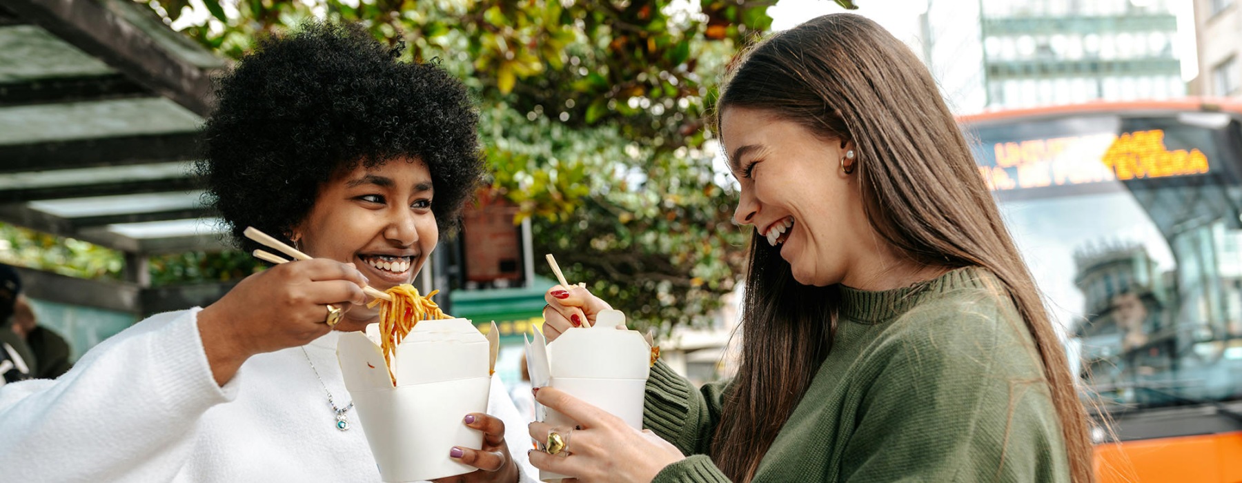 people outdoors smiling and eating