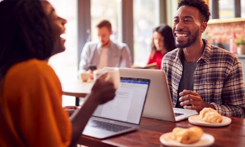 smiling man and woman in coffee shop